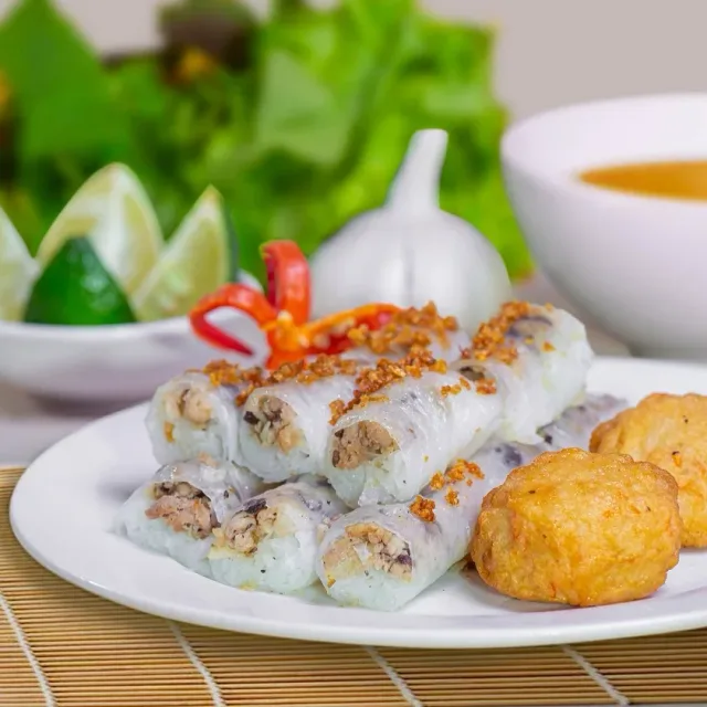 Bánh cuốn rice rolls and golden savoury cakes on a white plate