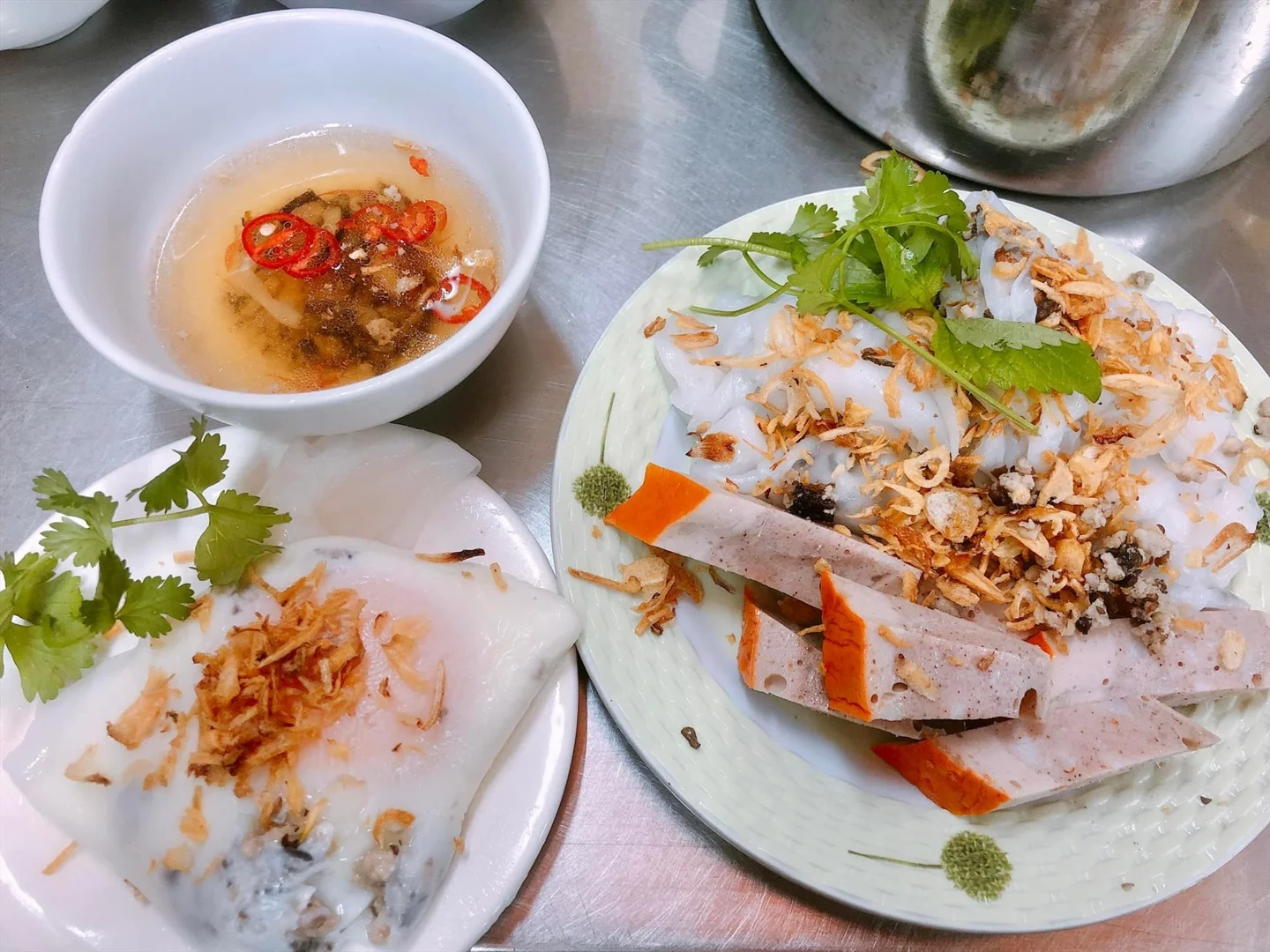 Bánh cuốn topped with shallots, beside chả lụa and dipping sauce