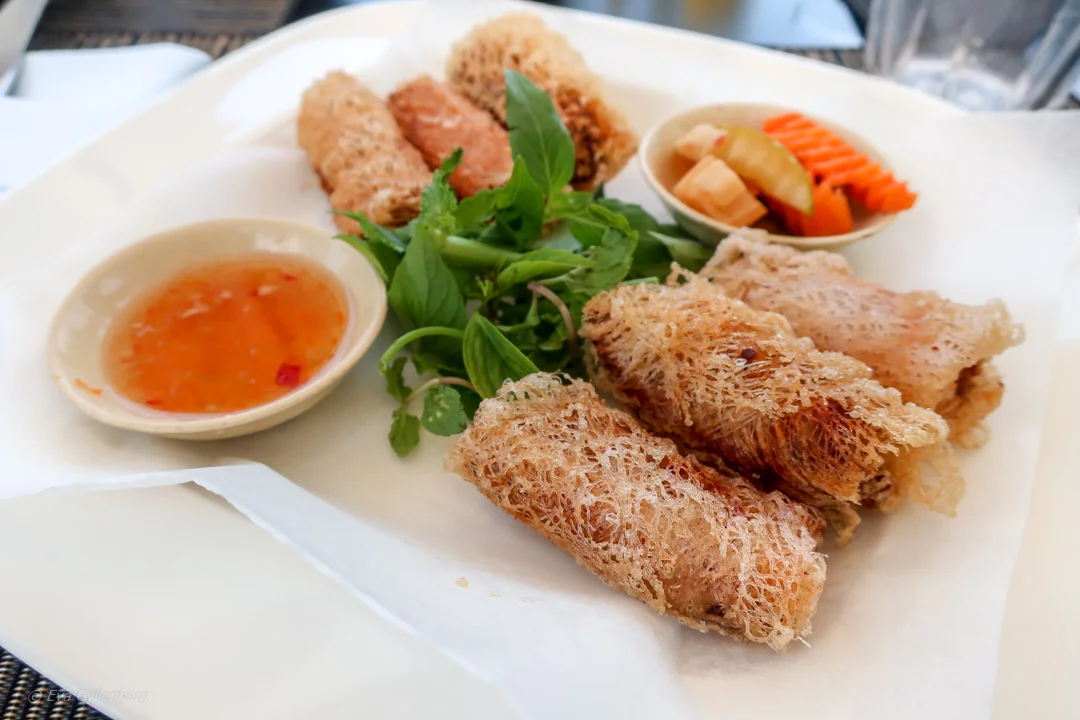Crisp fried spring rolls with herbs, pickled vegetables and dipping sauce