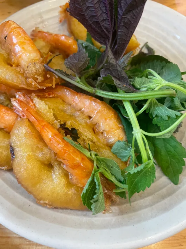 Whole shrimp on golden fried fritters with perilla and other herbs