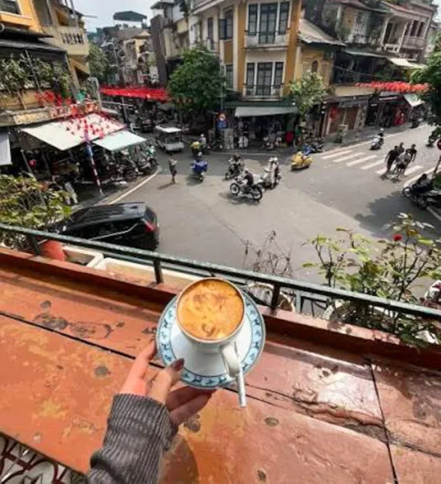 Vietnamese coffee brewing in a phin filter beside roasted beans